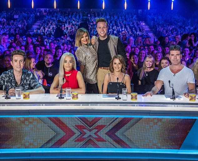 EVENT: **STRICTLY NO WEB USAGE UNTIL 11:59 (GMT) 08/07/2015** X Factor Judges Simon Cowell, Cheryl Fernedez-Versini, Rita Ora and Nick Grimshaw line up as the new judging panel for X Factor 2015! Also seen are Caroline Flack and Olly Murs who will be presenting for this years hopeful contestants! **MANDORTARY BYLINE: SYCO / THAMES / CORBIS**