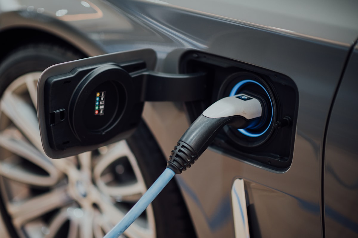 An electric car being charged with a cable