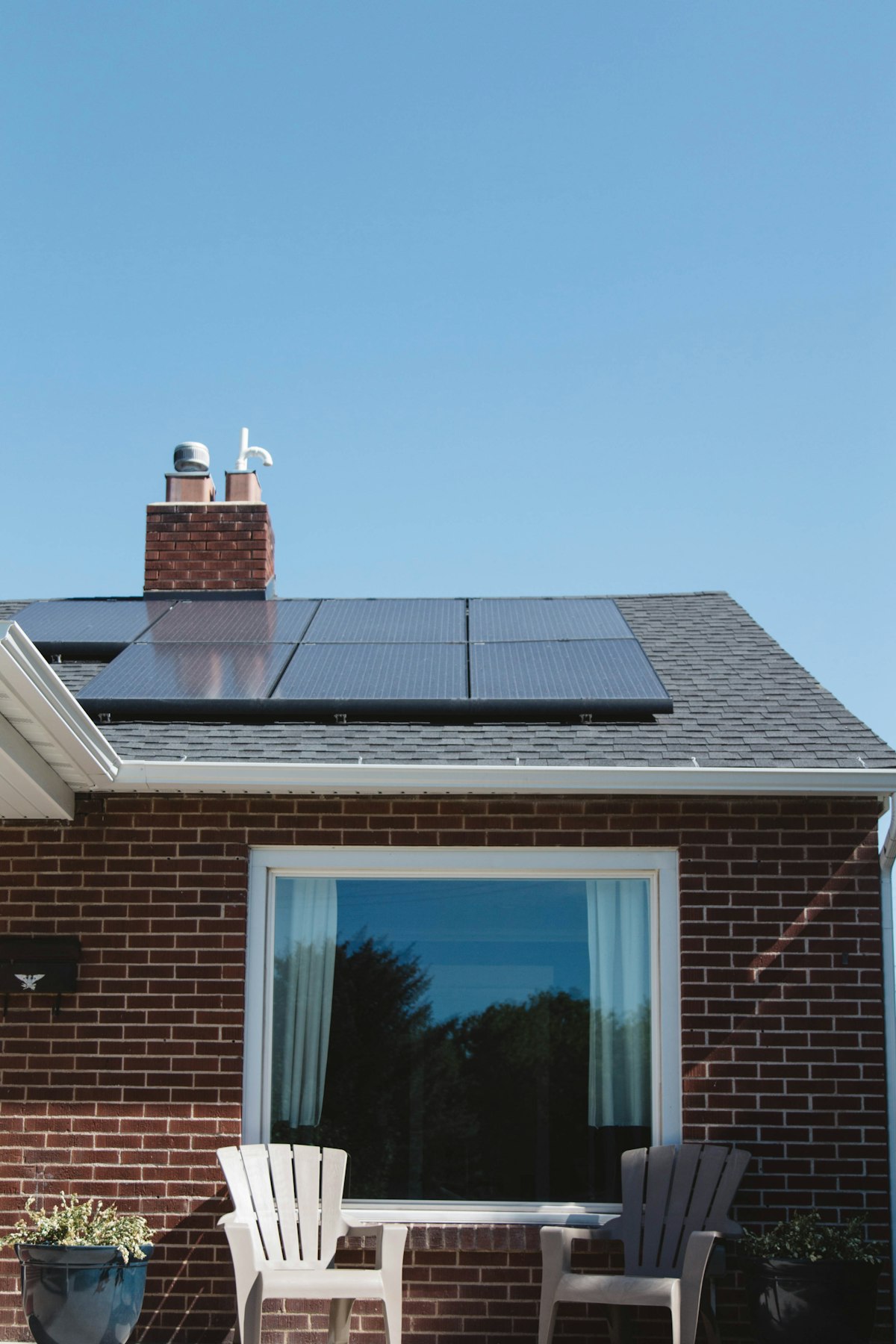 Solar panels on the roof of a brick house