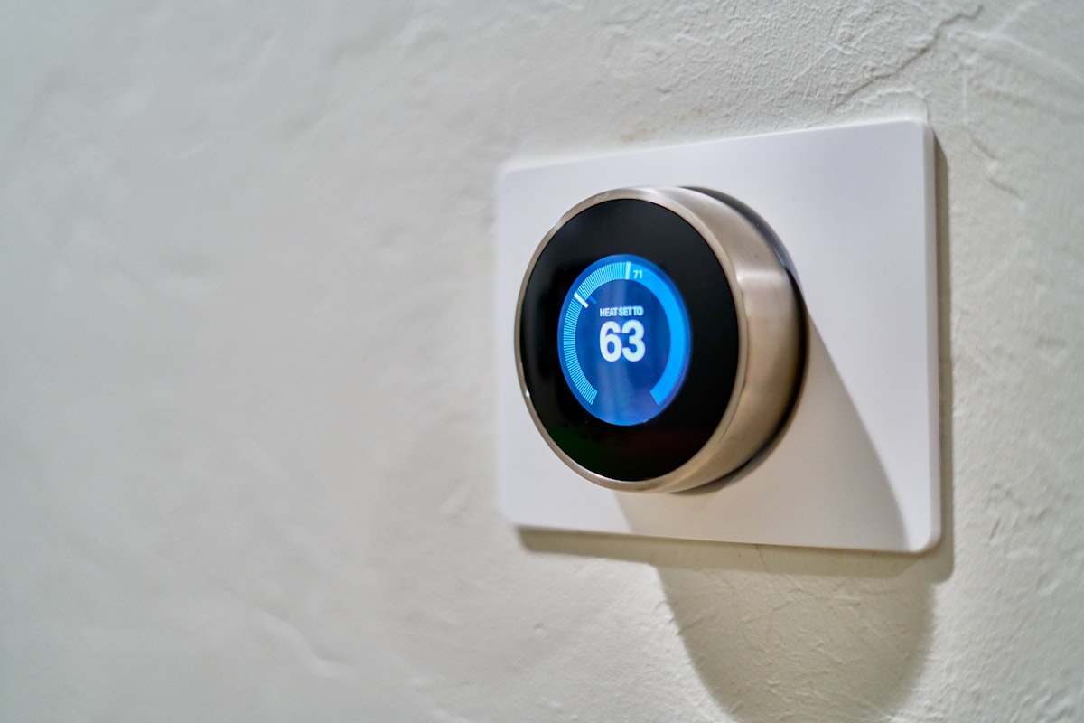 A smart thermostat on the wall of a home