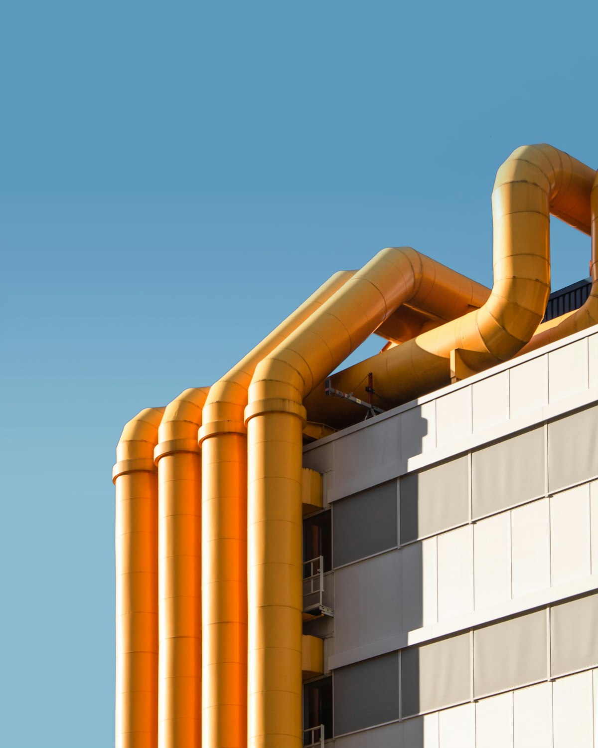 Large heating pipes running along a building